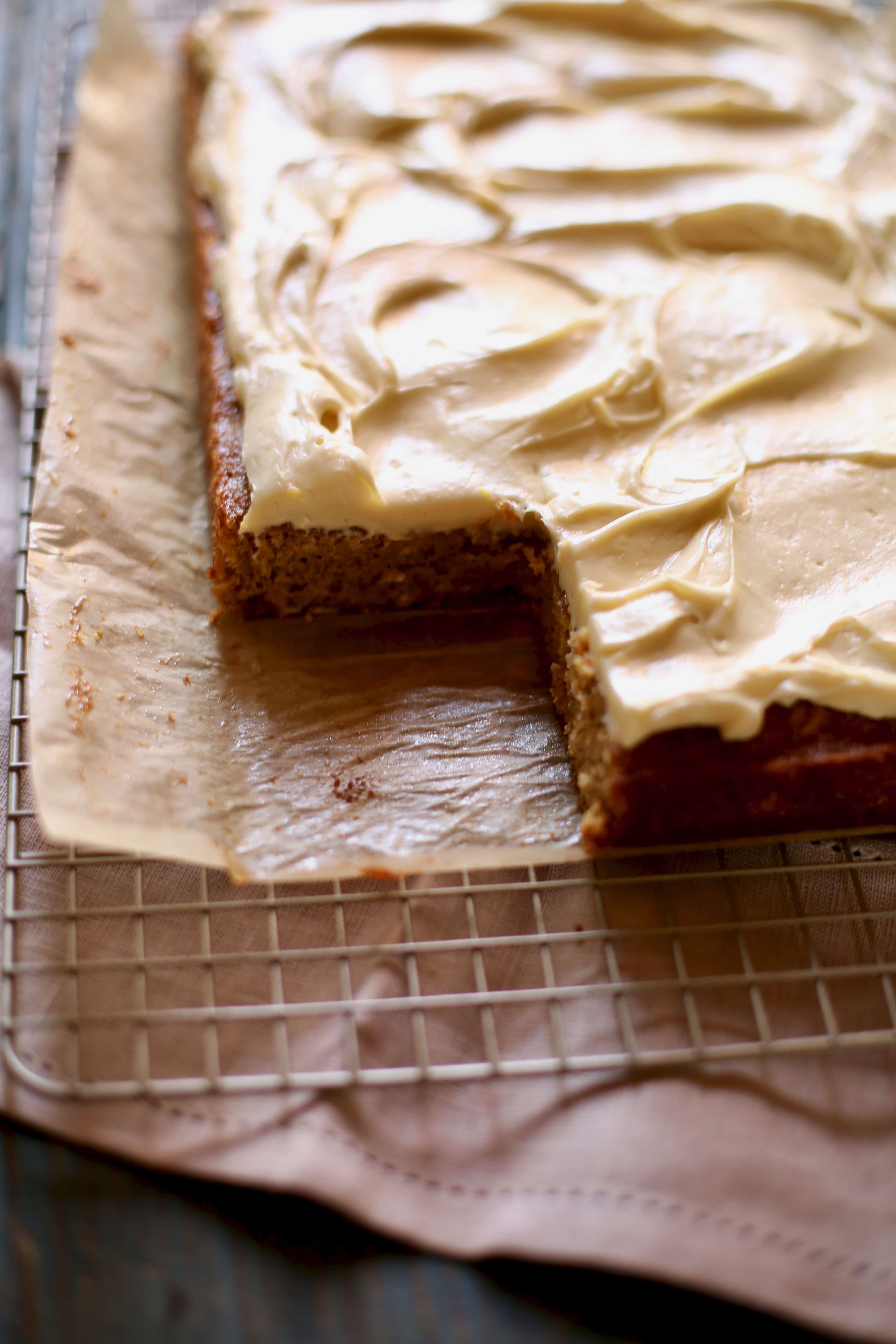 a fresh banana cake with a slice removed on the corner