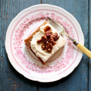 a piece of cake on a pink and white plate with a yellow fork