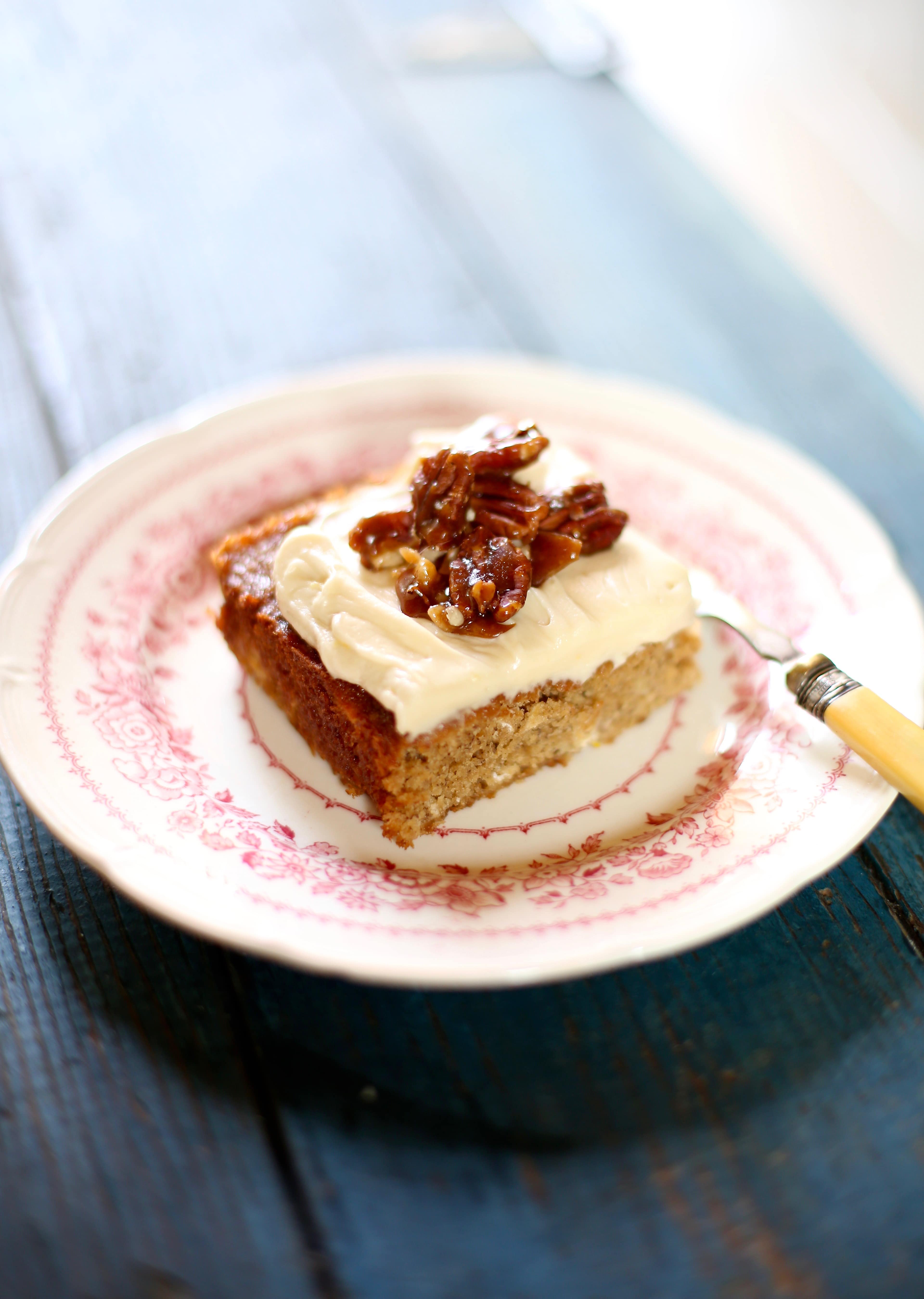 a piece of fresh banana cake on a pink and white plate