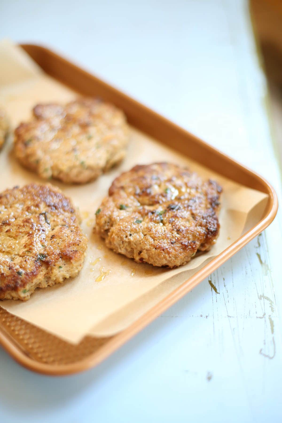 Turkey burger patties on a baking sheet