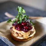 turkey burger with cranberry on a silver tray
