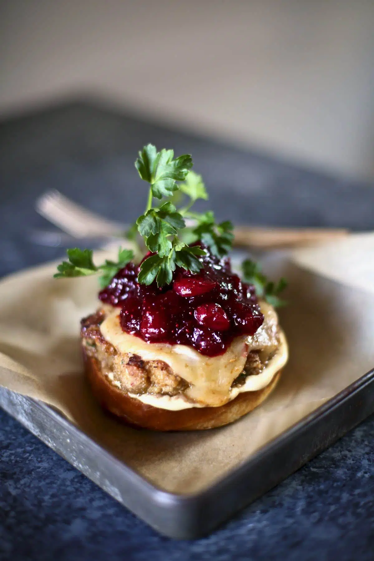 turkey burger with cranberry on a silver tray