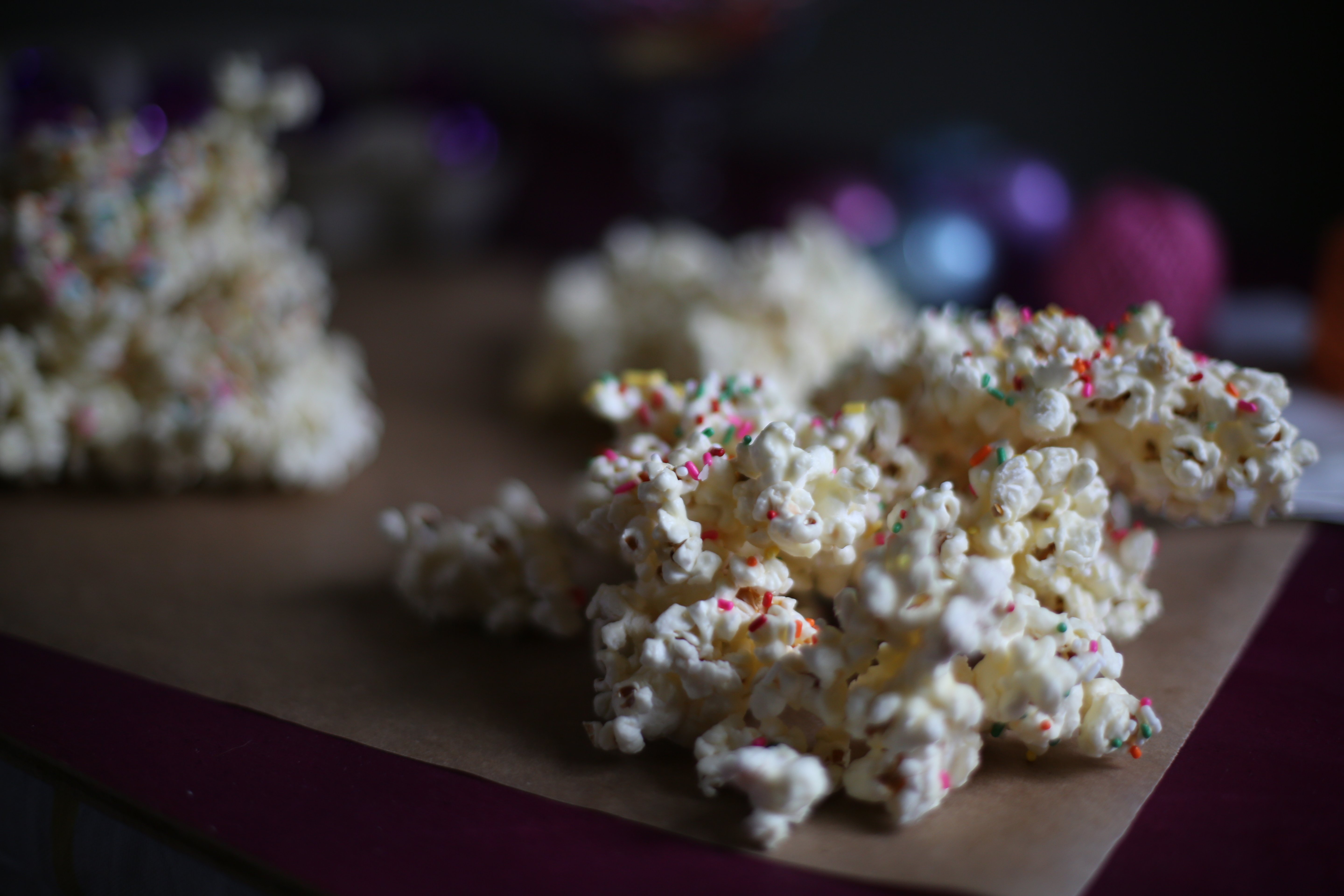 White Chocolate popcorn on a table with sprinkles 