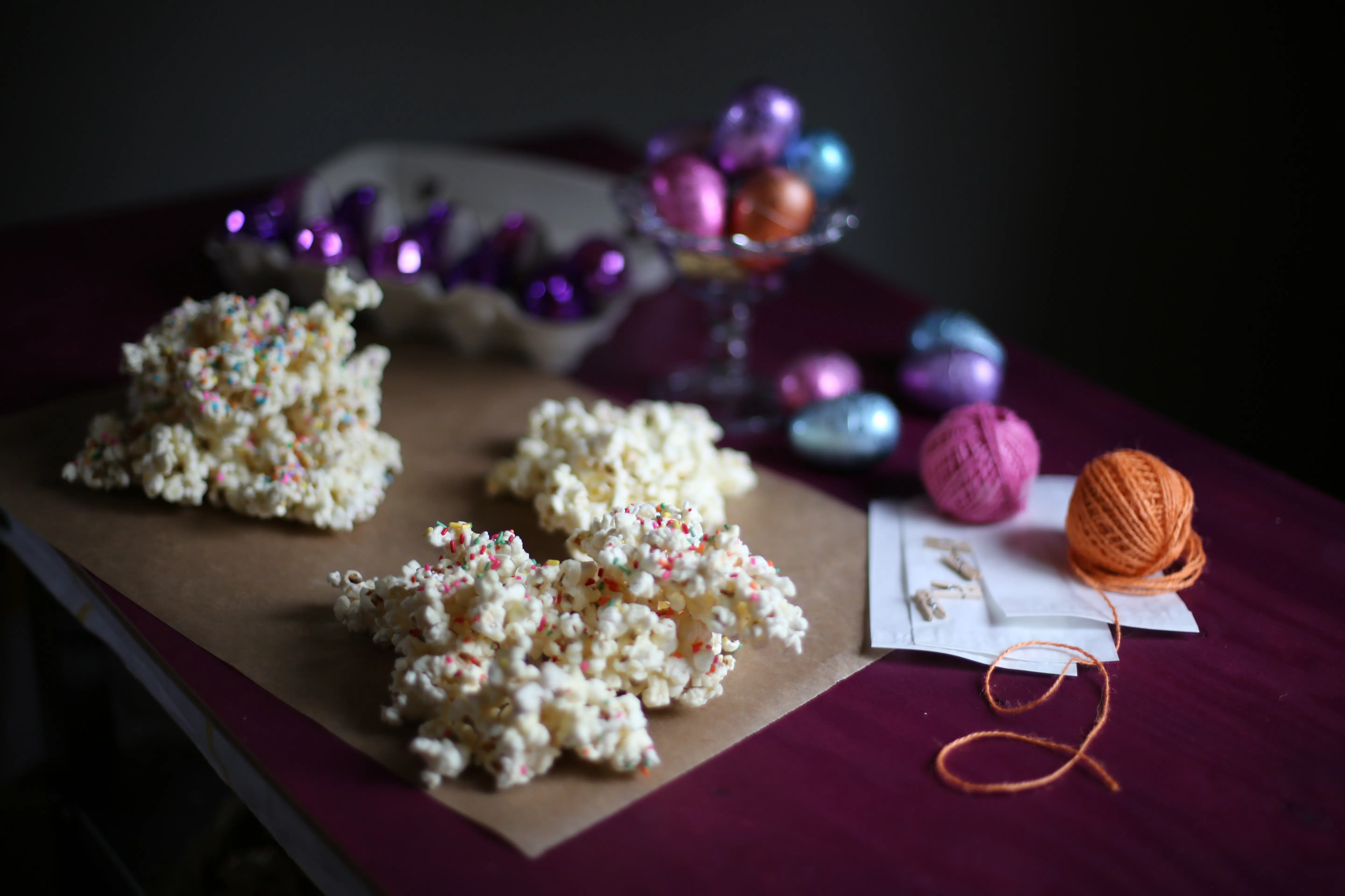 popcorn on a wooden table with decorations behind it 