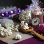 popcorn on a table with a wooden spoon