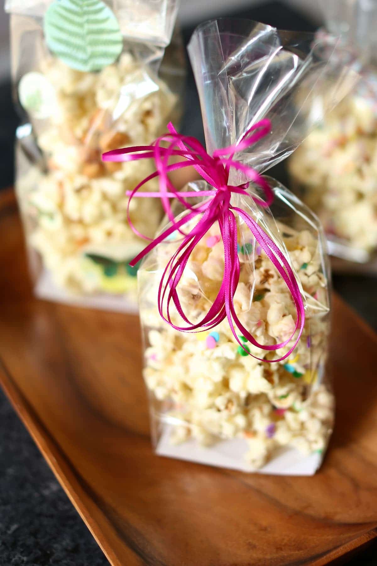a bag of popcorn with a pink ribbon.