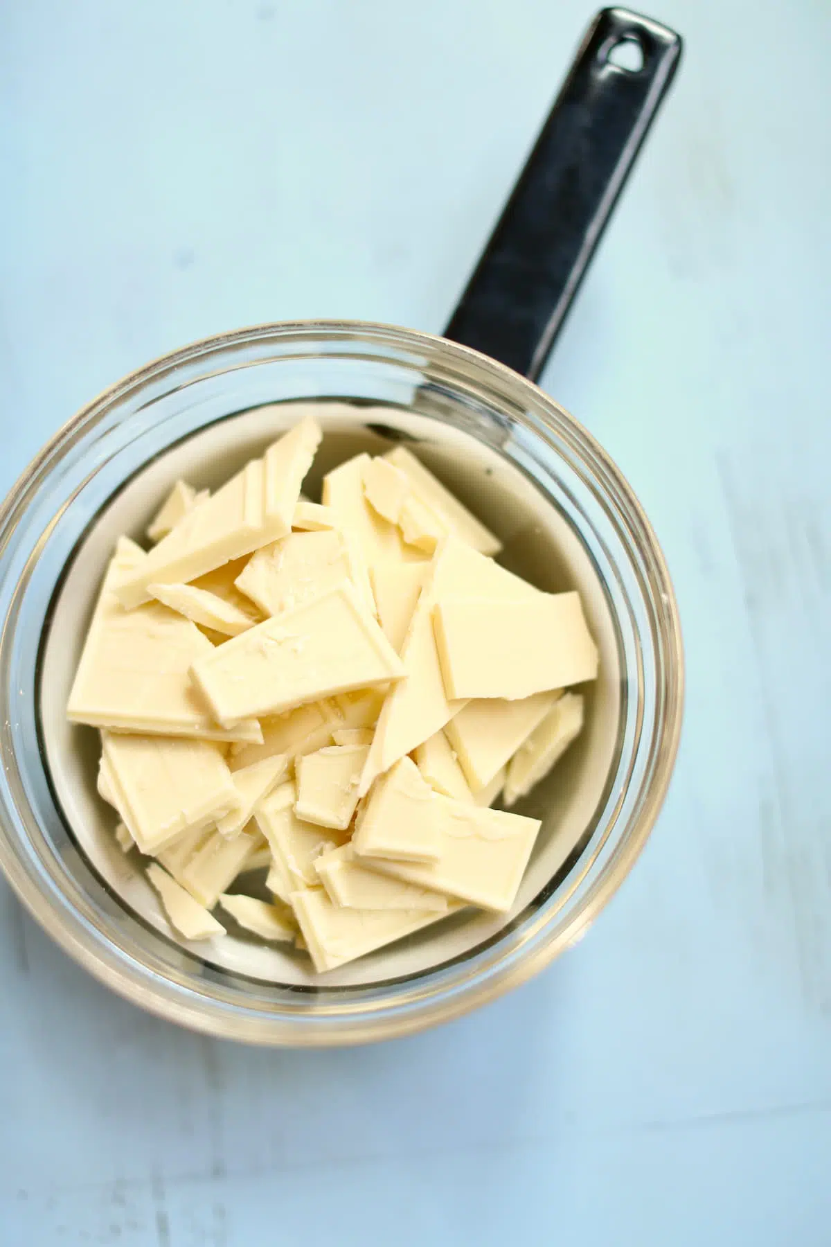 a glass bowl of white chocolate pieces.