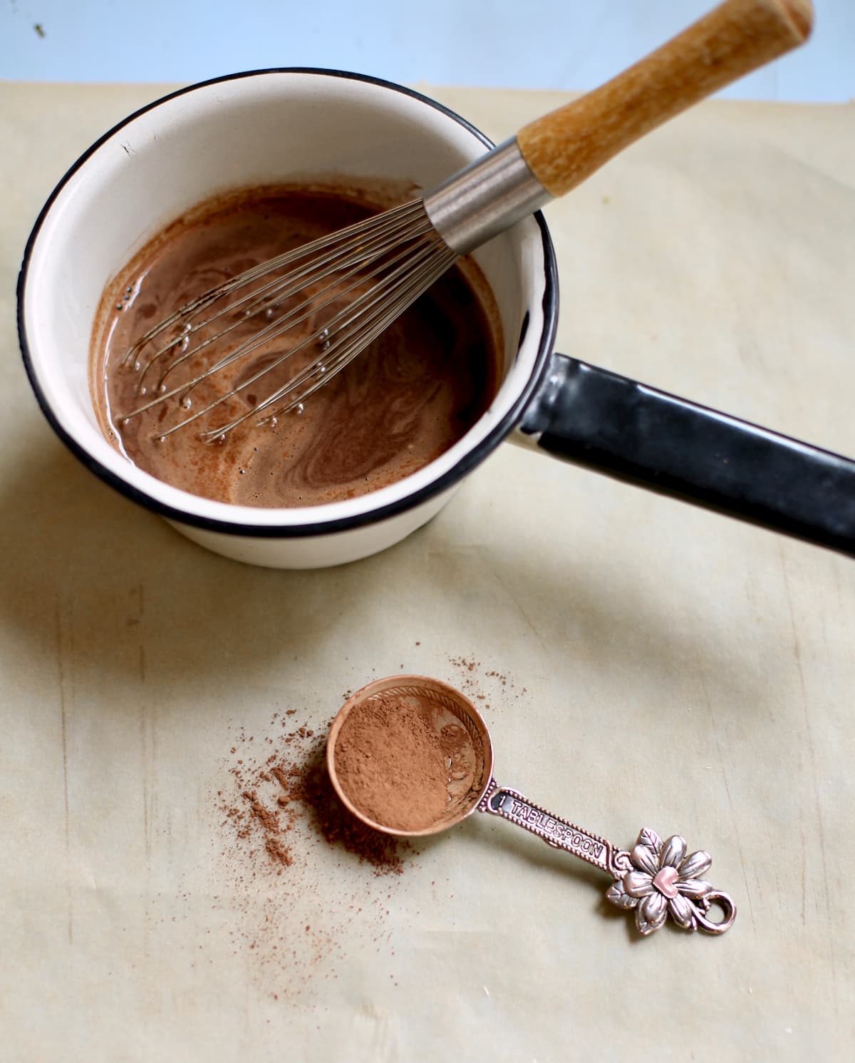 saucepan of hot chocolate and a measuring spoon