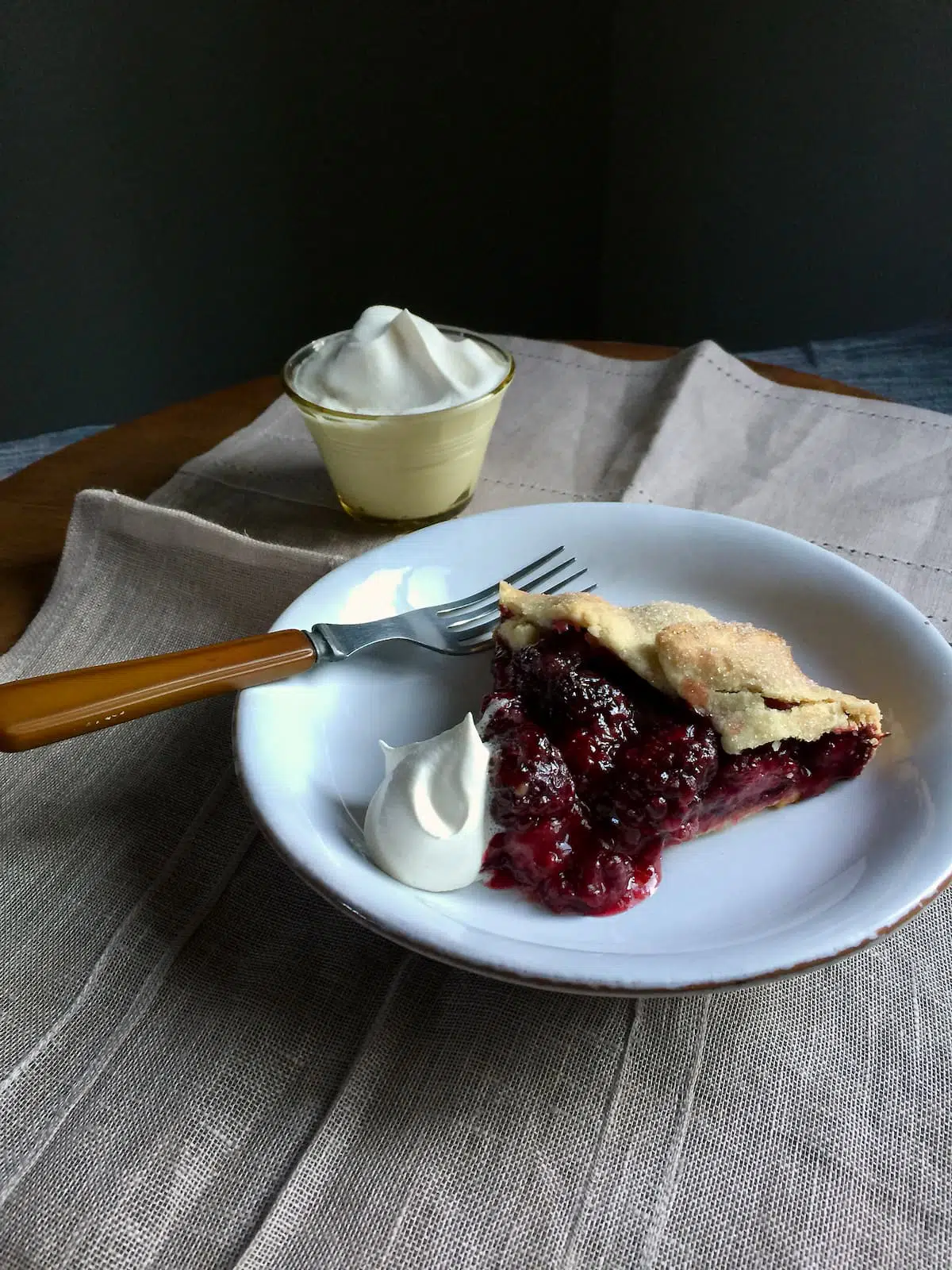 a piece of pie on a white plate with a fork.