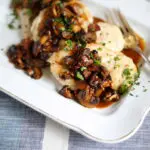 chicken and mushrooms on a white platter