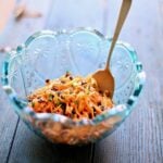 carrot salad in a blue bowl in a wood table