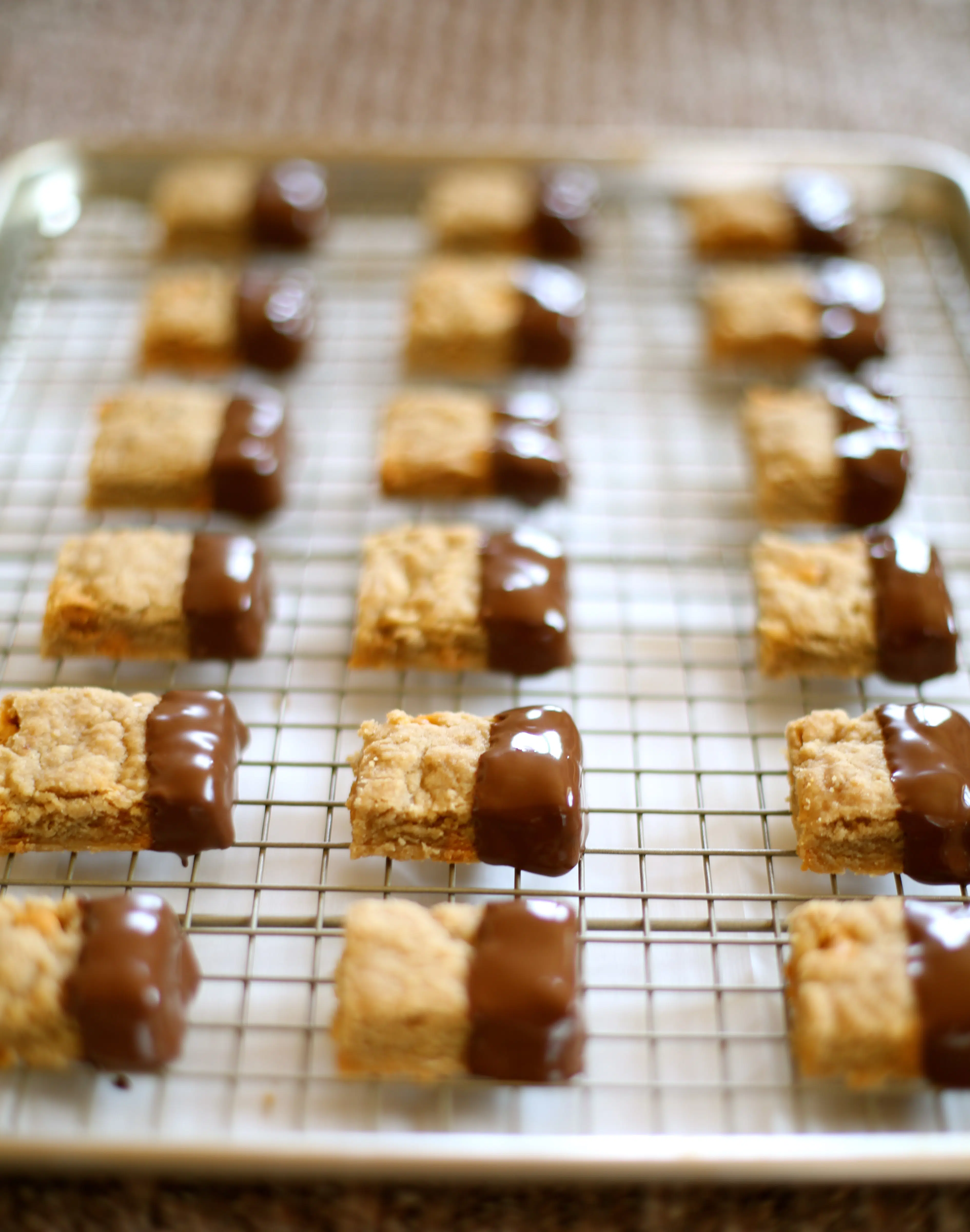  Shortbread cookies dipped in Chocolate on a cooling rack.  