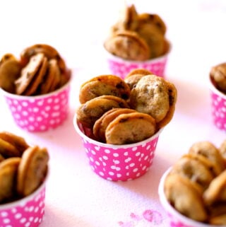 small cookies in pink cups on a table