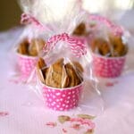 small chocolate chip cookies in pink cups with cellophane