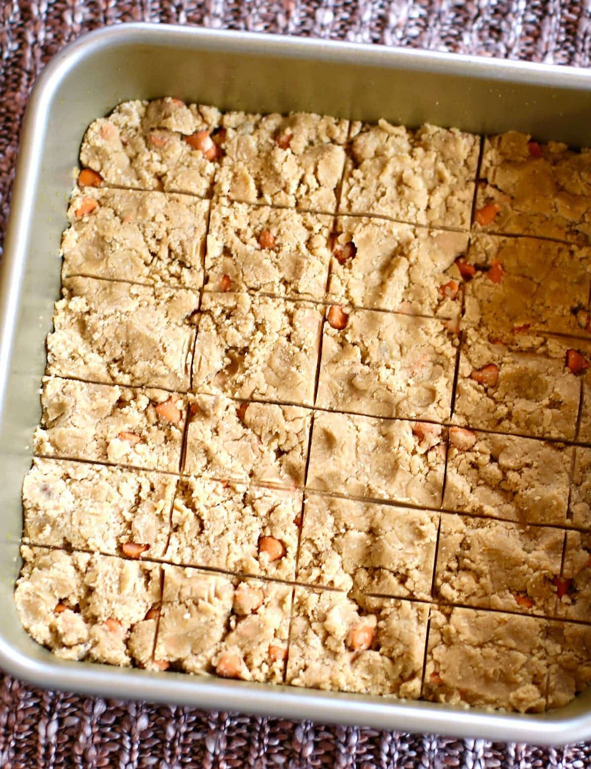 a tray of uncooked shortbread in a pan.