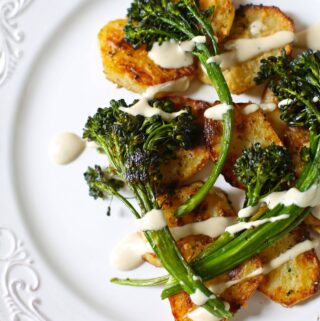 broccolini and potatoes on a white platter