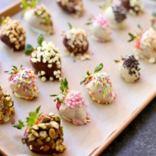 a tray of chocolate dipped strawberries on a tray