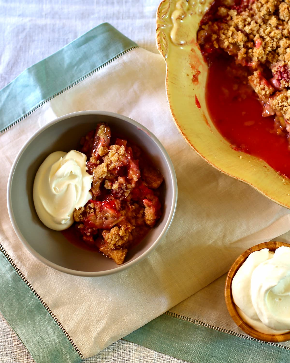 a bowl of rhubarb crumble on a table.