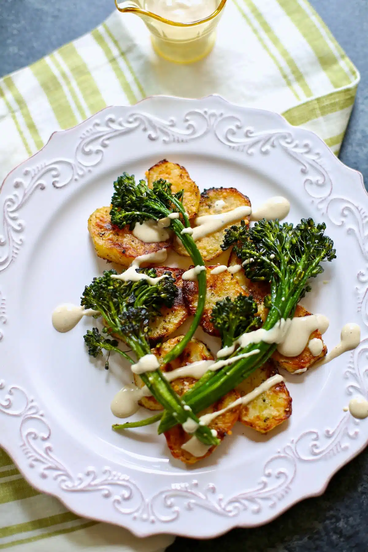 a plate of potatoes and broccolini.  