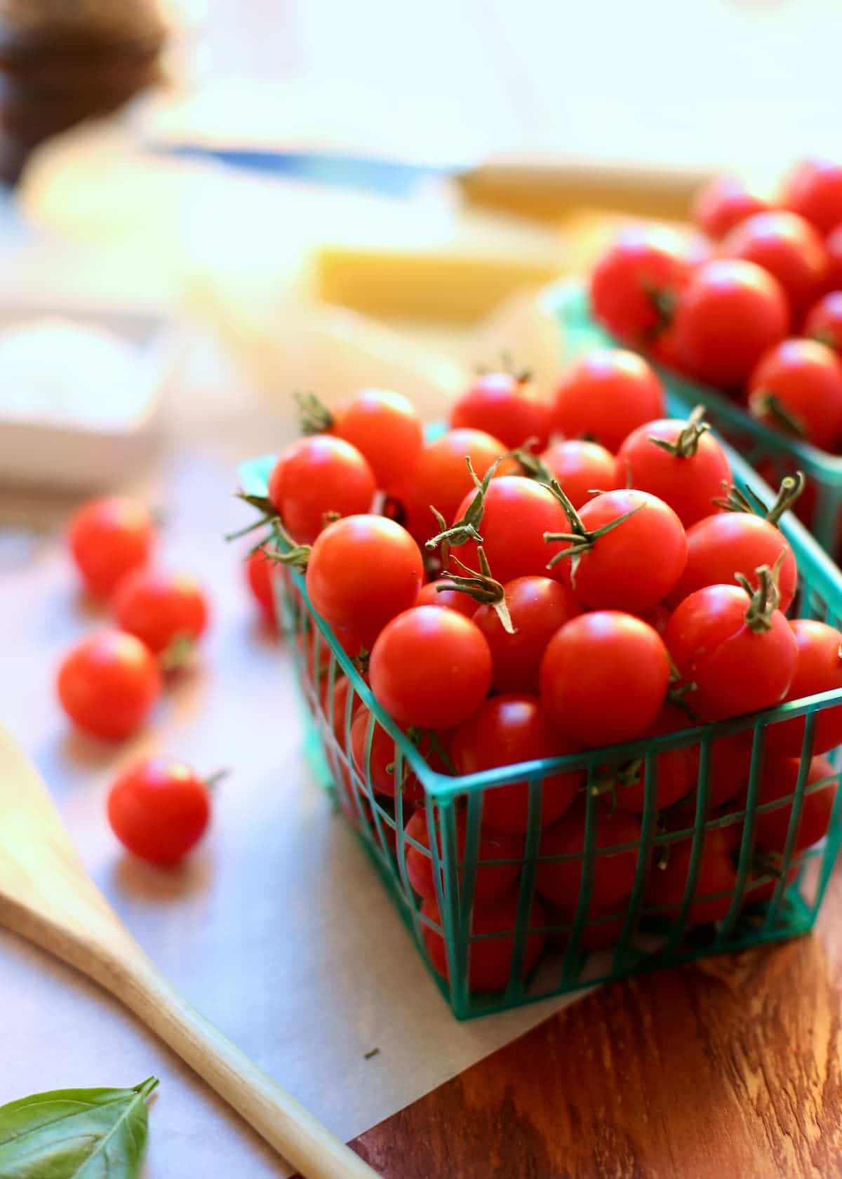 a container of cherry tomatoes on a table.