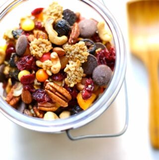 trail mix in a container with wooden spoon