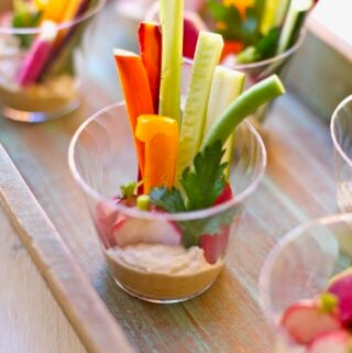 veggies in a plastic cup with hummus