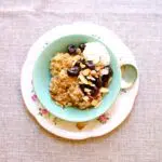 Oatmeal with Cherry Almond Compote in a dish on a small platter and bowl