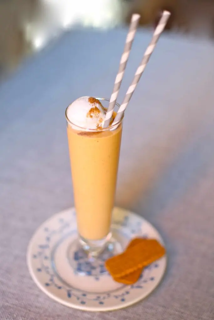 Pumpkin Milkshake on a plate with a cookie