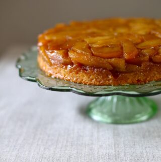 Apple Upside Down Cake on a green glass cake stand
