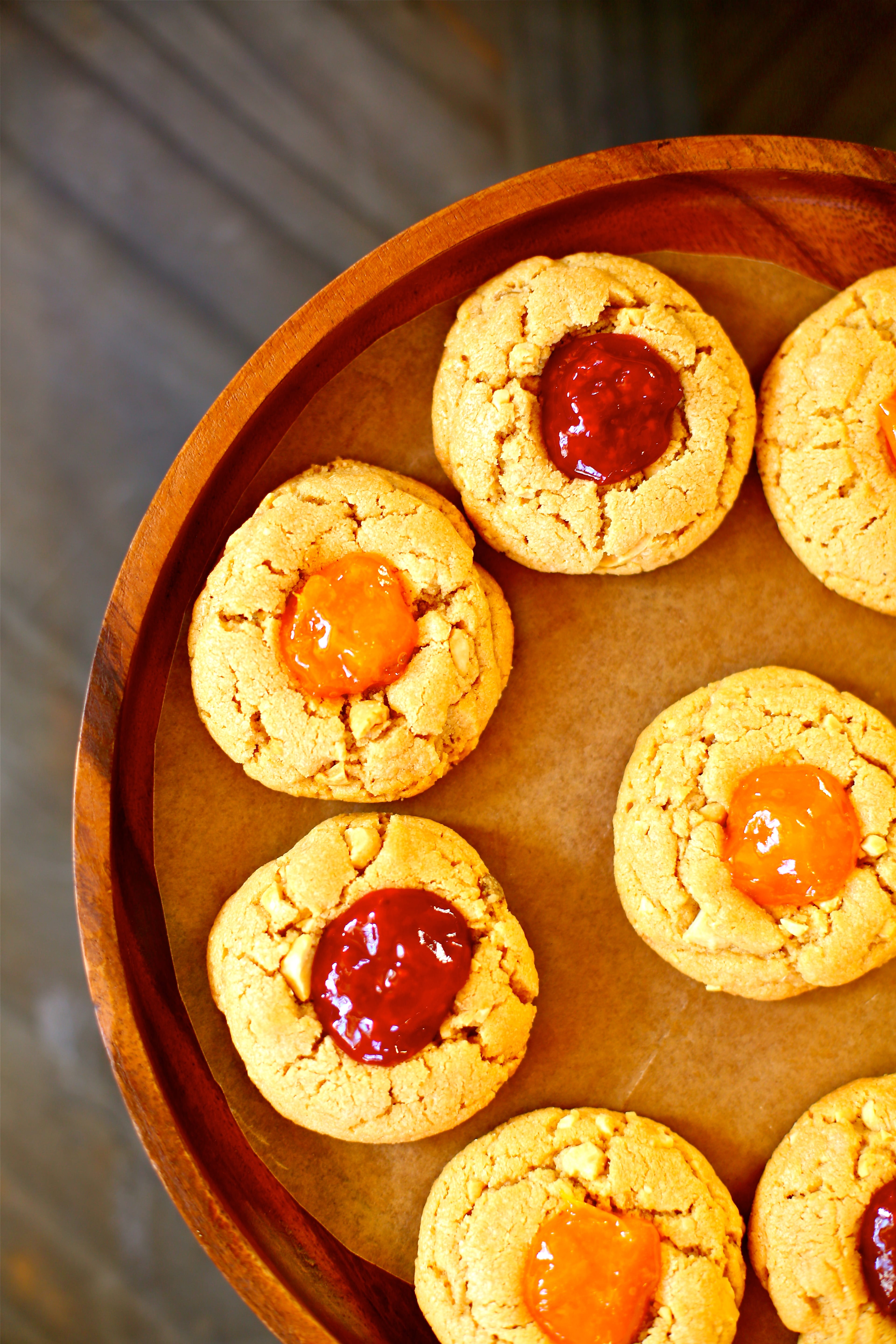 Peanut Butter and Jam Cookies on a wooden platter 
