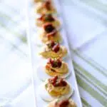 a photo of deviled eggs with candied bacon, and text overlay saying the recipe name.