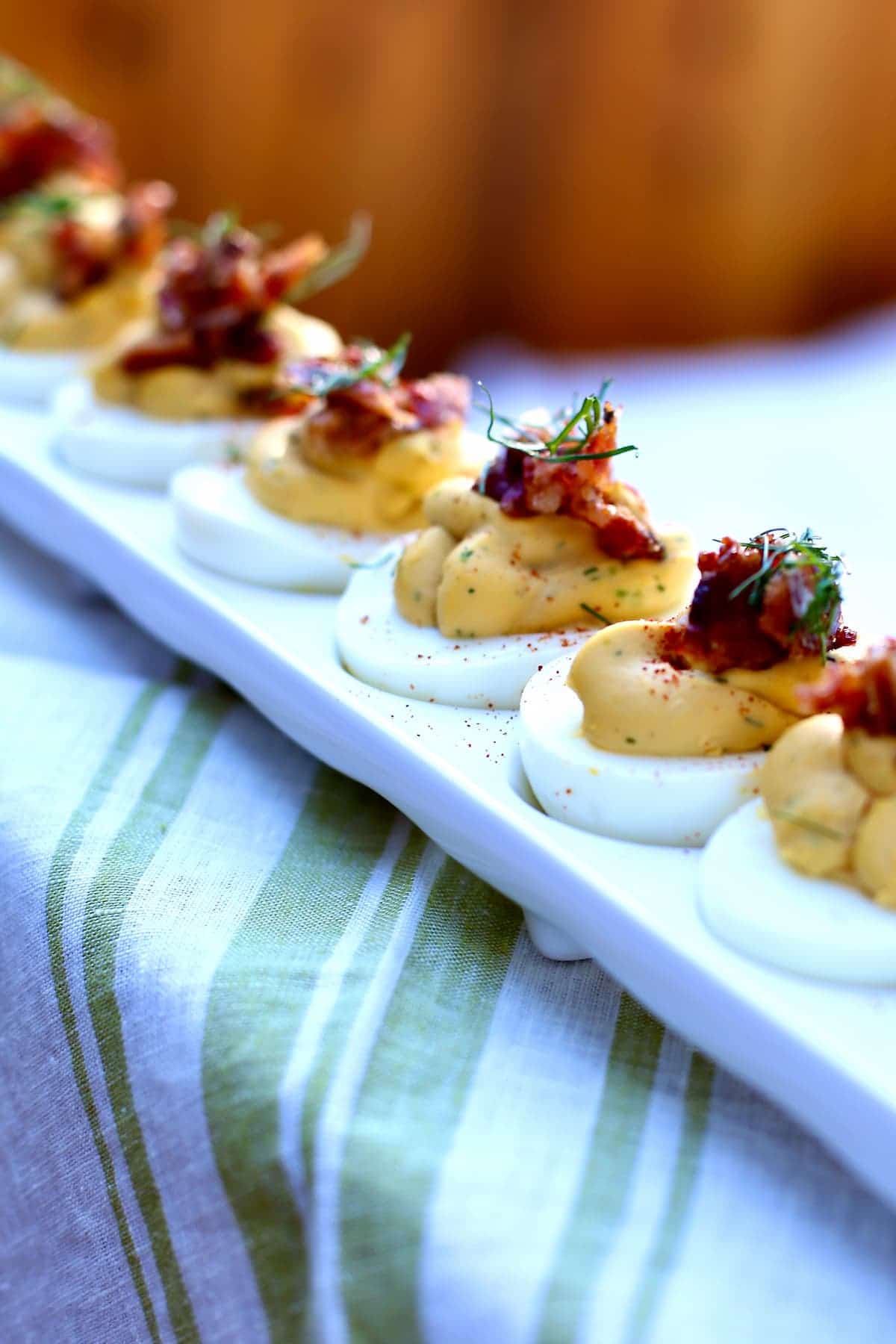 a photo of deviled eggs close up on a special platter.