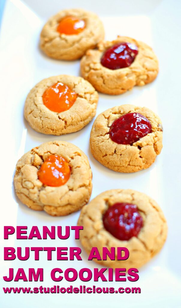 Peanut Butter and Jam Cookies on a white platter with cherry and apricot jam 