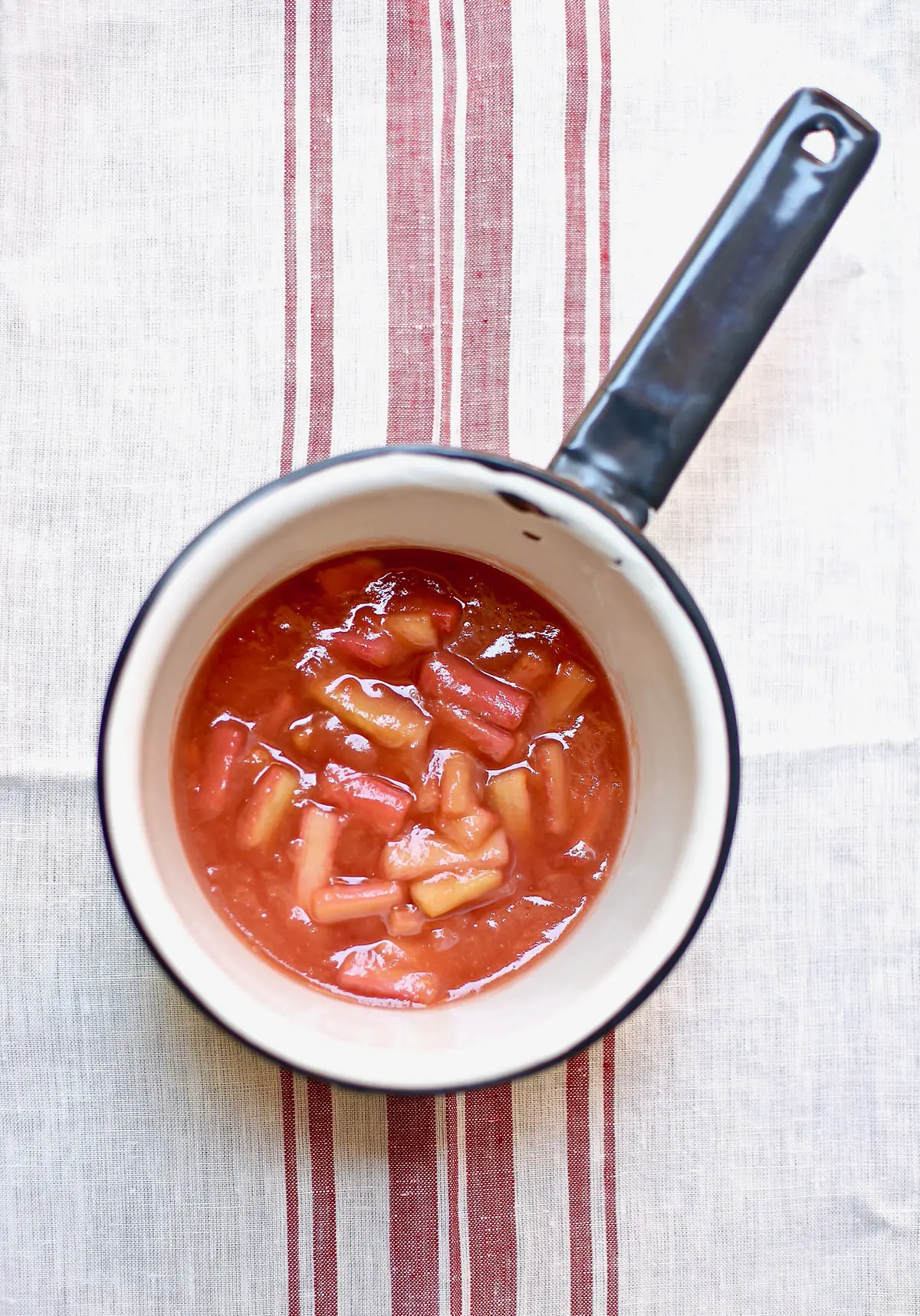 cooked rhubarb in a white saucepan