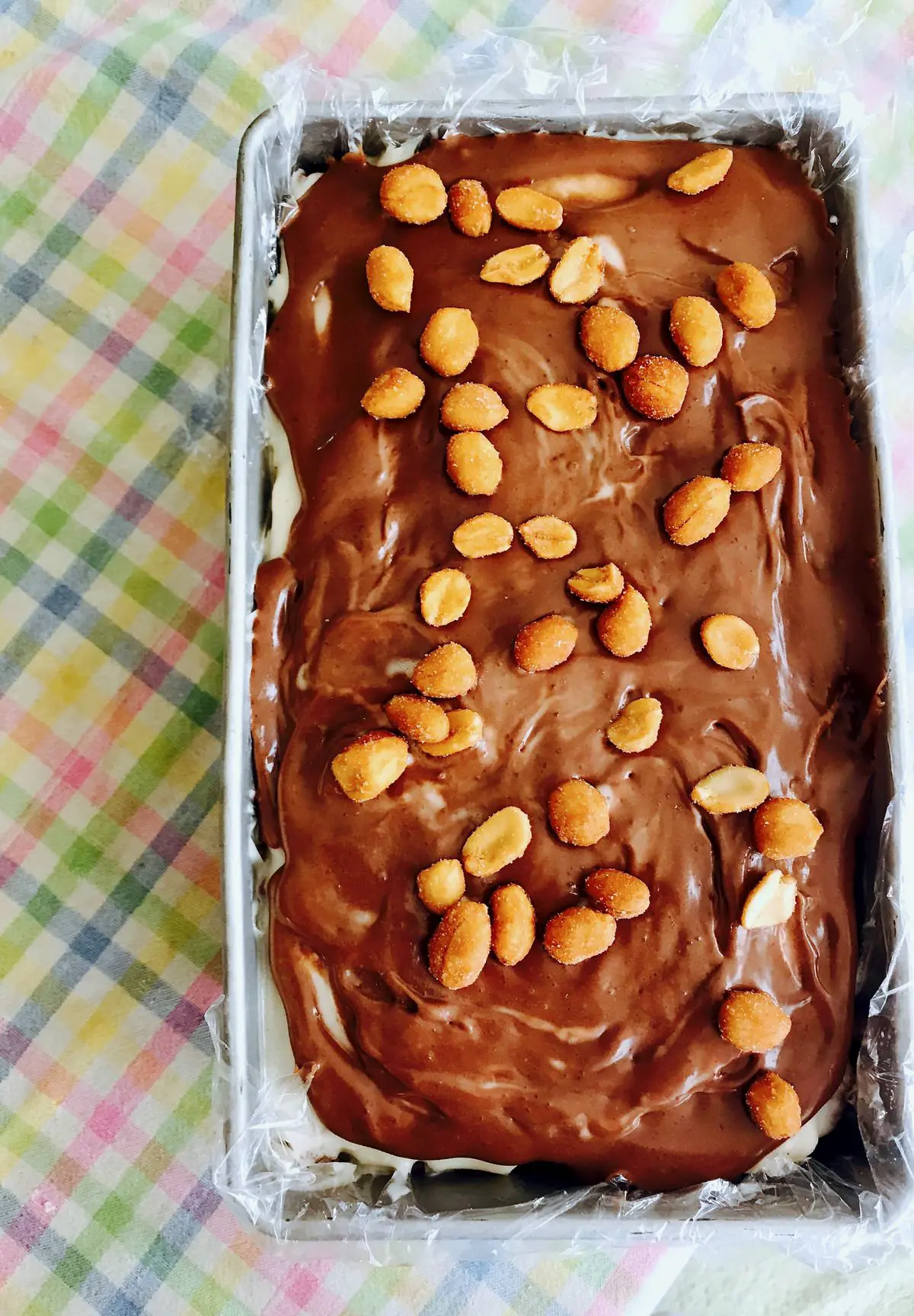 ice cream cake in a loaf pan on a striped tablecloth