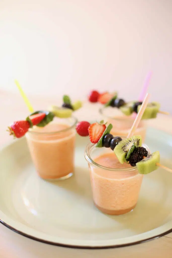 frozen slushees on a tray with fruit kabobs