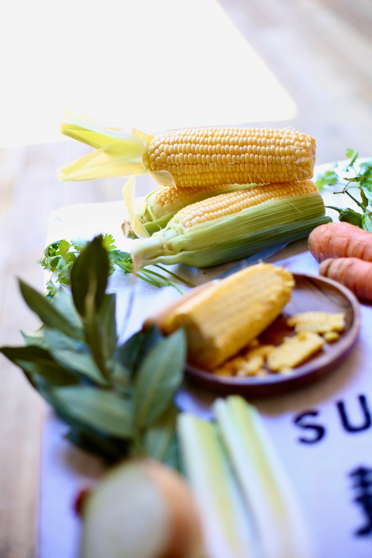 a table with fresh corn thats been cut off the cob. 