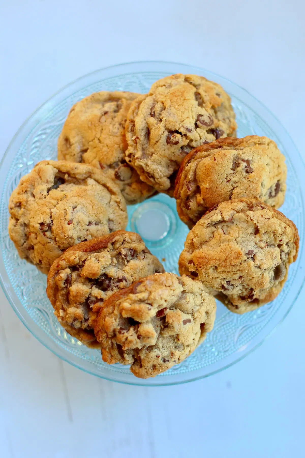 a circle of chocolate chip cookies on a blue table