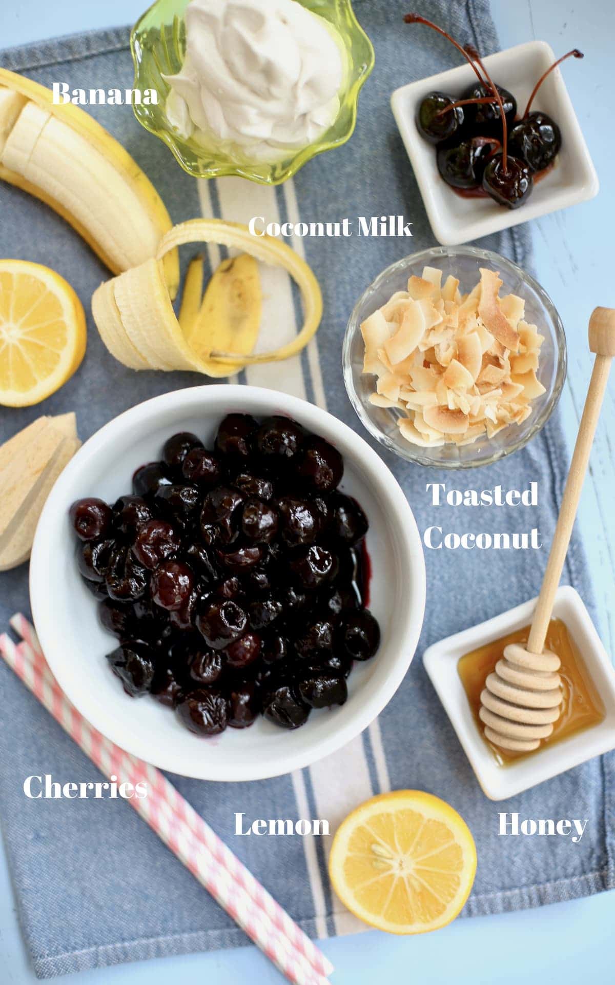 cherries banana coconut coconut milk hiney and lemon on a blue tablecloth with text