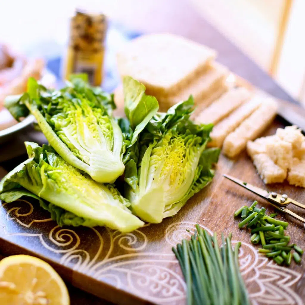 a table filled with salad ingredients.