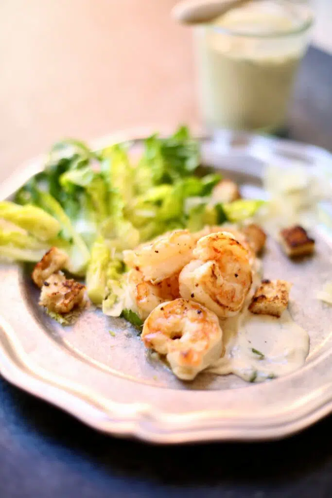 a salad platter showing some shrimp piled high in the middle.