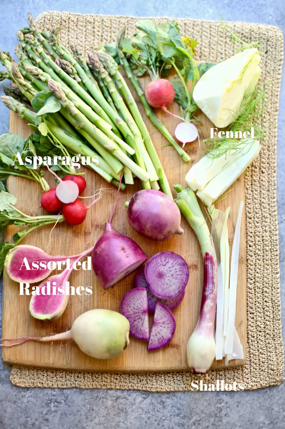 spring vegetables on a cutting board with text
