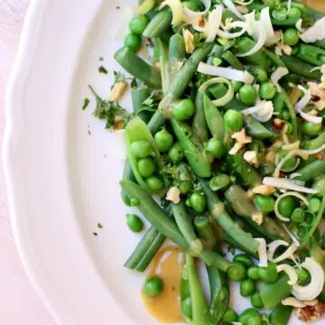 a green vegetable salad on a white platter.