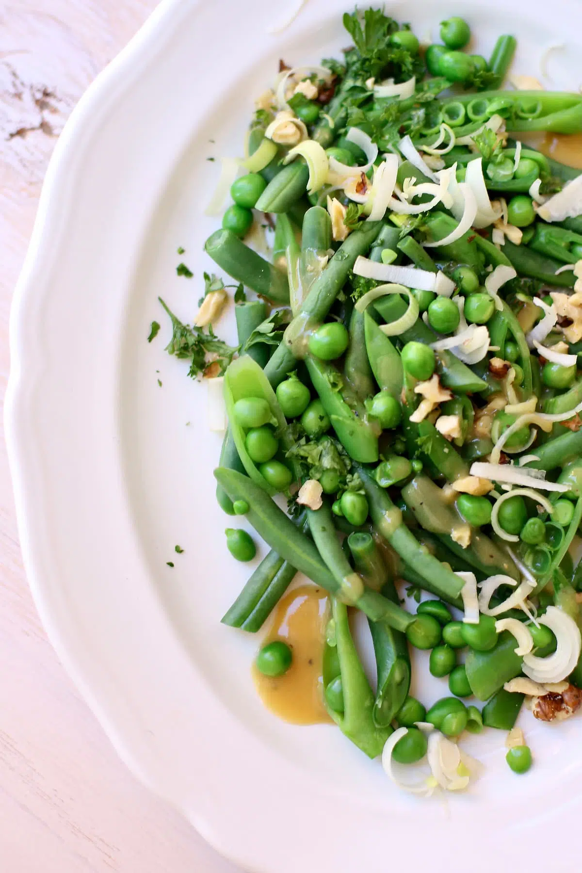 a green vegetable salad on a white platter.