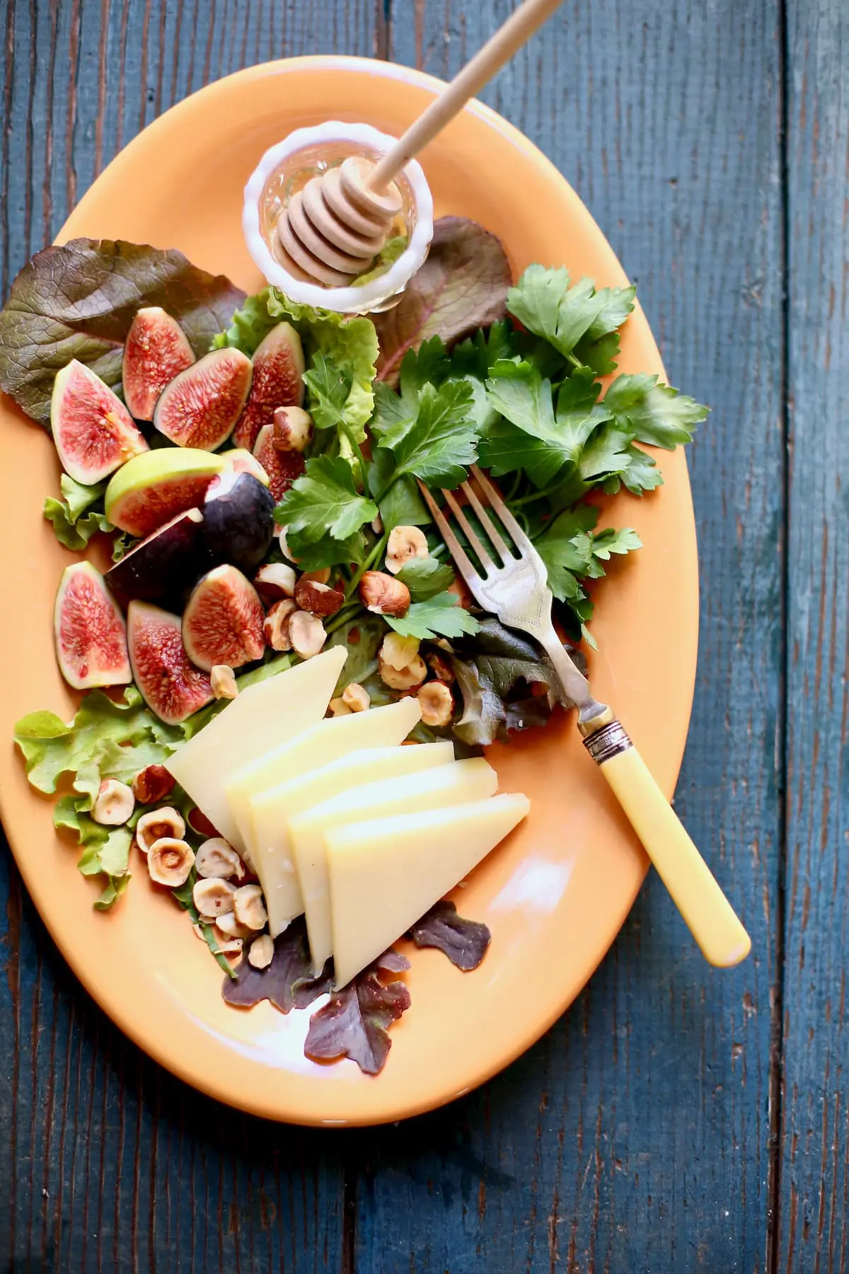 fig and cheese on an orange platter
