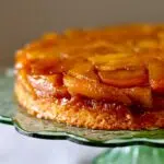 a close up photo of fresh apple cake on a green glass stand with text overlay saying the recipe name.