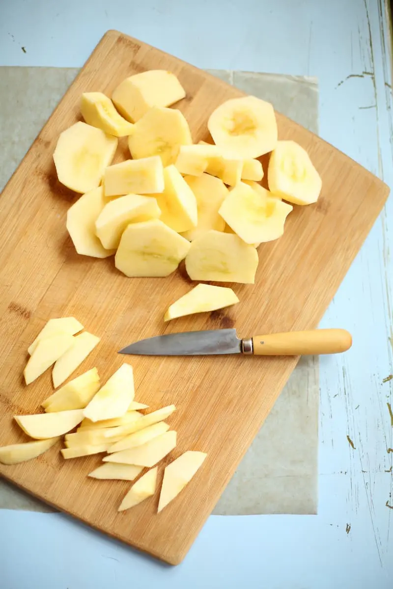 apples on a cutting board with a knife 