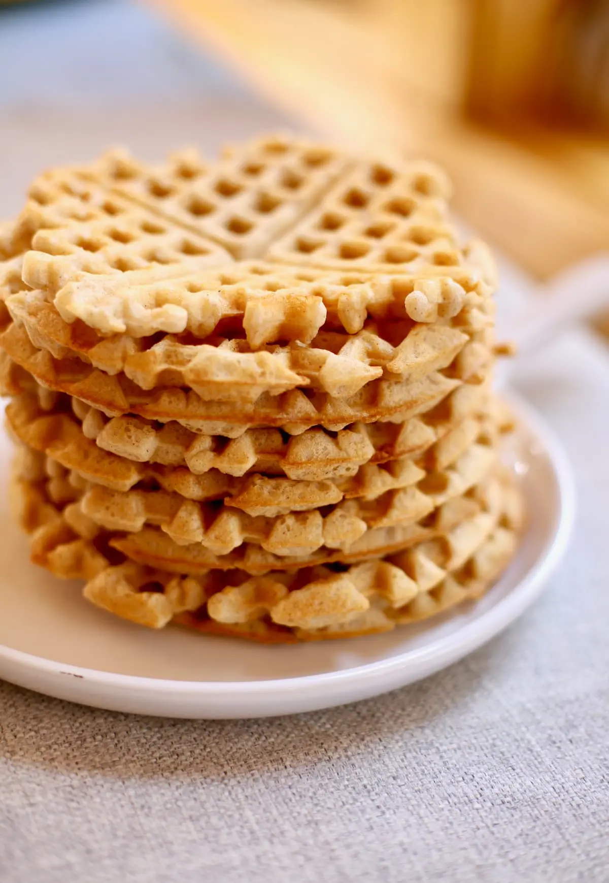 a stack of waffles on a white plate