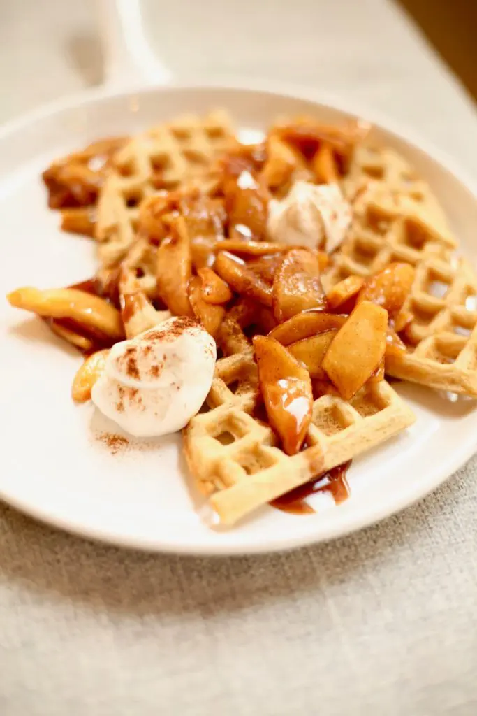 waffles with apples on a white plate