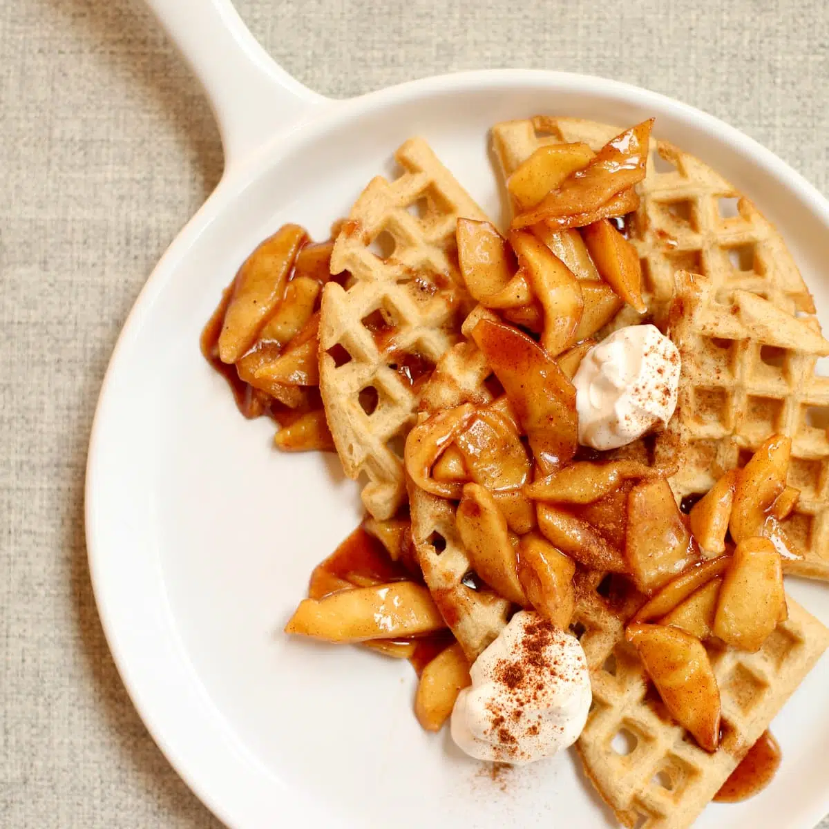 a square image of waffles with apples.